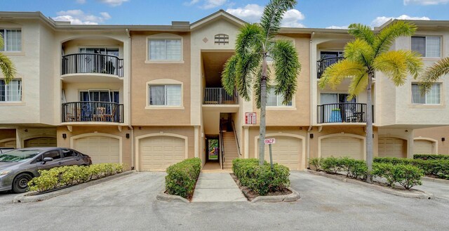 view of front of house with a garage and a balcony