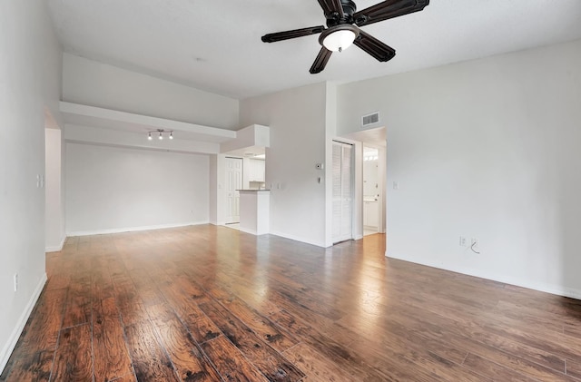 unfurnished living room with ceiling fan and wood-type flooring