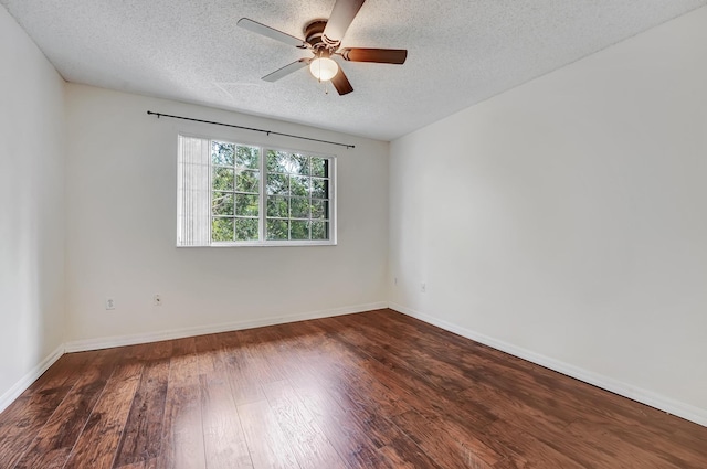 empty room featuring ceiling fan, dark hardwood / wood-style floors, and a textured ceiling