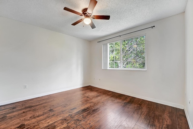 empty room with dark wood-type flooring, a textured ceiling, and ceiling fan