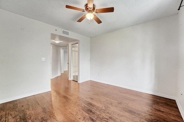 spare room with wood-type flooring, a textured ceiling, and ceiling fan