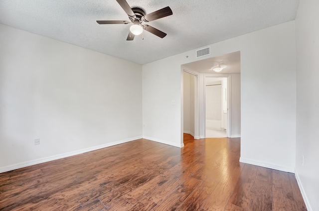 unfurnished room featuring ceiling fan, wood-type flooring, and a textured ceiling