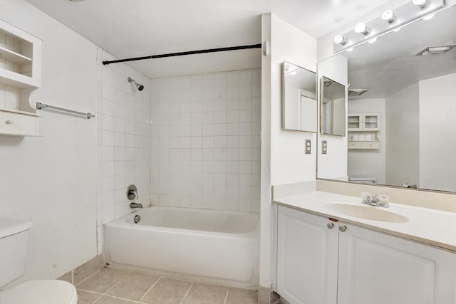 full bathroom with tiled shower / bath combo, toilet, tile patterned flooring, and vanity