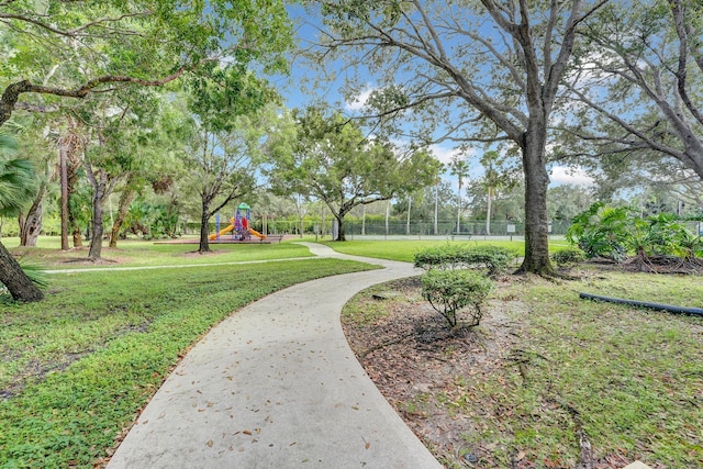 surrounding community with a playground and a yard