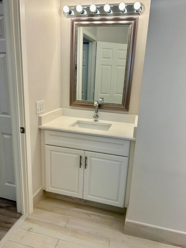 bathroom featuring vanity and hardwood / wood-style flooring