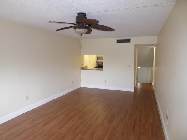 unfurnished living room featuring dark hardwood / wood-style floors, ceiling fan, and a textured ceiling