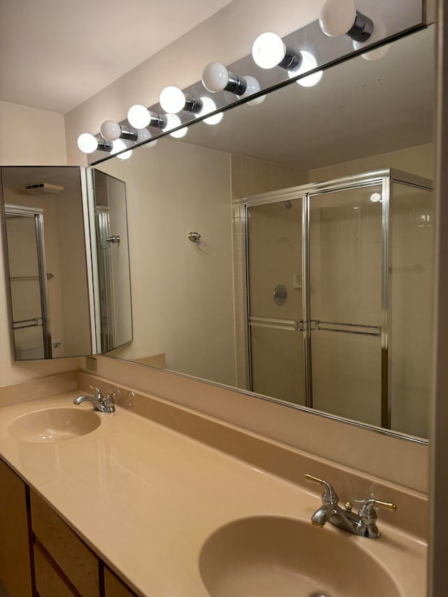 bathroom featuring vanity and a shower with shower door