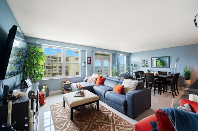 tiled living room featuring french doors and a healthy amount of sunlight