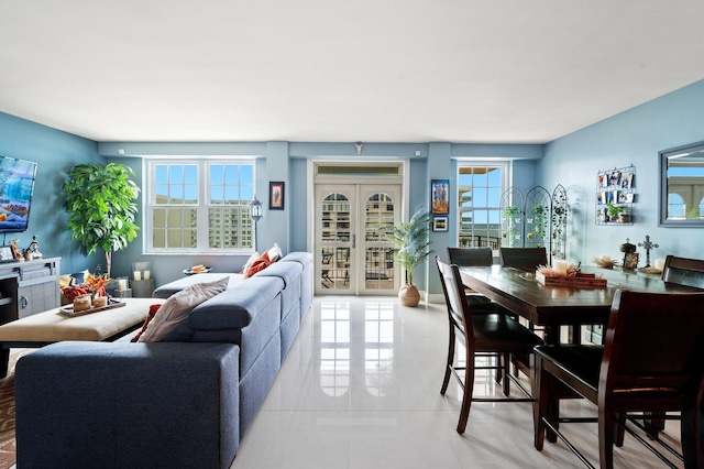 living room featuring french doors and light tile patterned flooring