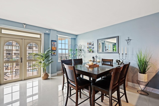 tiled dining area featuring french doors