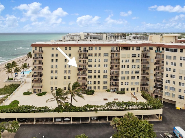 view of building exterior featuring a view of the beach and a water view