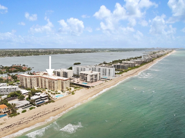 birds eye view of property featuring a view of the beach and a water view