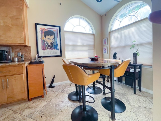 dining space featuring lofted ceiling