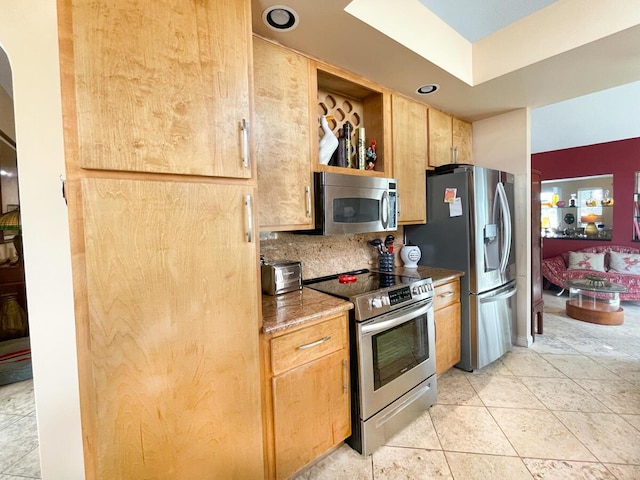 kitchen with appliances with stainless steel finishes, tasteful backsplash, and light tile patterned floors