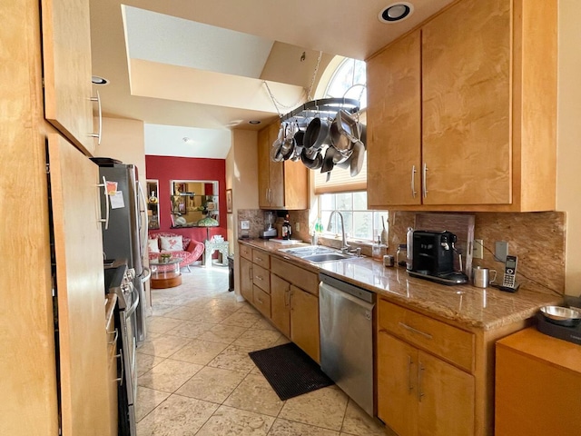 kitchen featuring tasteful backsplash, sink, light tile patterned floors, and appliances with stainless steel finishes