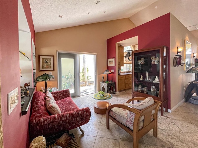 living area featuring lofted ceiling and a textured ceiling