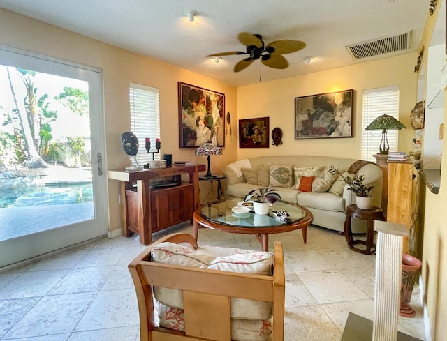 living room with ceiling fan and a healthy amount of sunlight