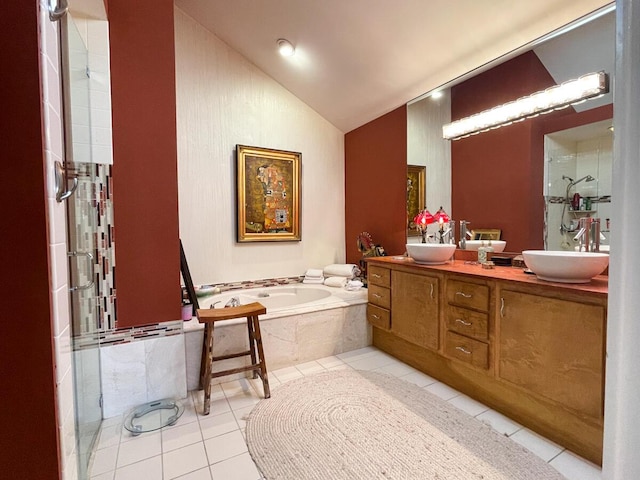 bathroom featuring tile patterned floors, vanity, a relaxing tiled tub, and vaulted ceiling