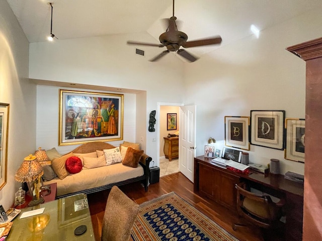 interior space with lofted ceiling, ceiling fan, and dark wood-type flooring