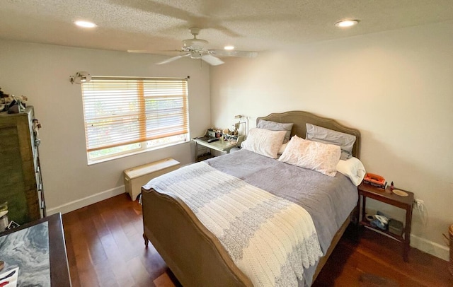 bedroom featuring ceiling fan, dark hardwood / wood-style floors, and a textured ceiling