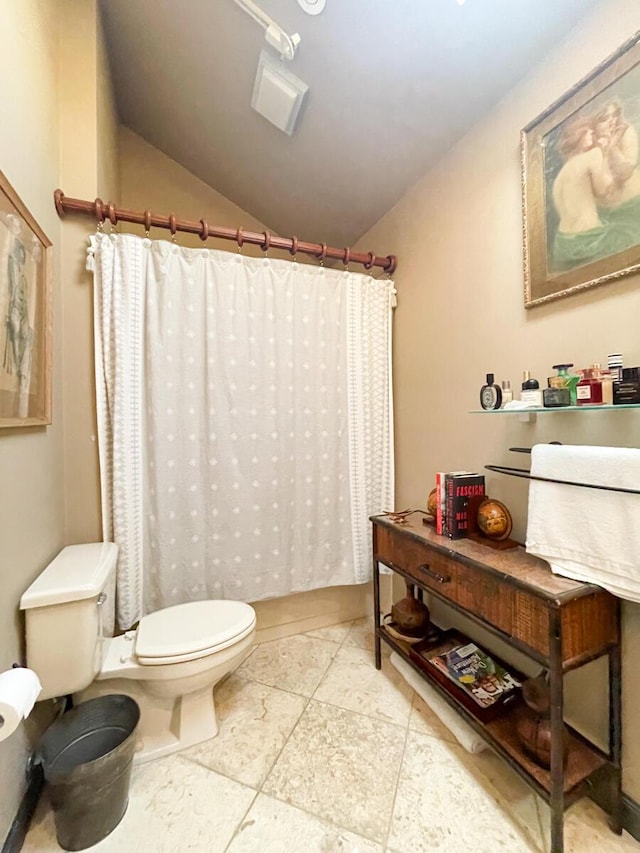 bathroom with vaulted ceiling and toilet