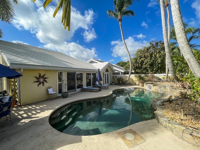 view of swimming pool featuring a patio and french doors