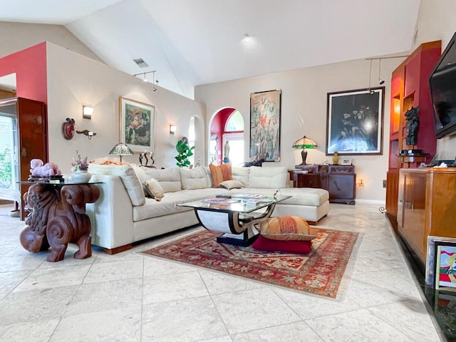 tiled living room with high vaulted ceiling