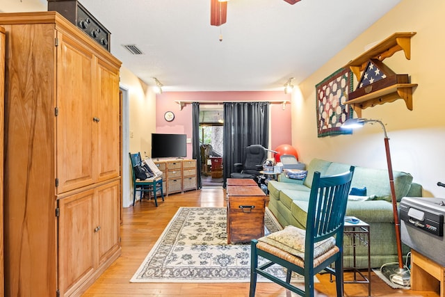 home office with ceiling fan and light wood-type flooring