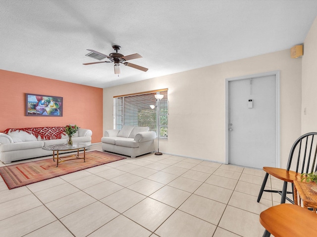 tiled living room with ceiling fan and a textured ceiling