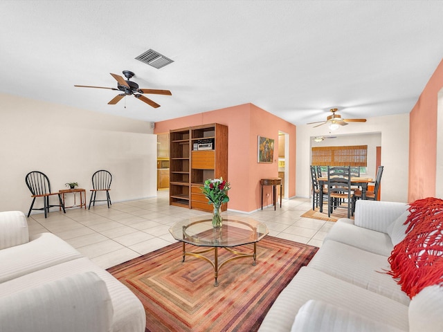 living room featuring light tile flooring and ceiling fan