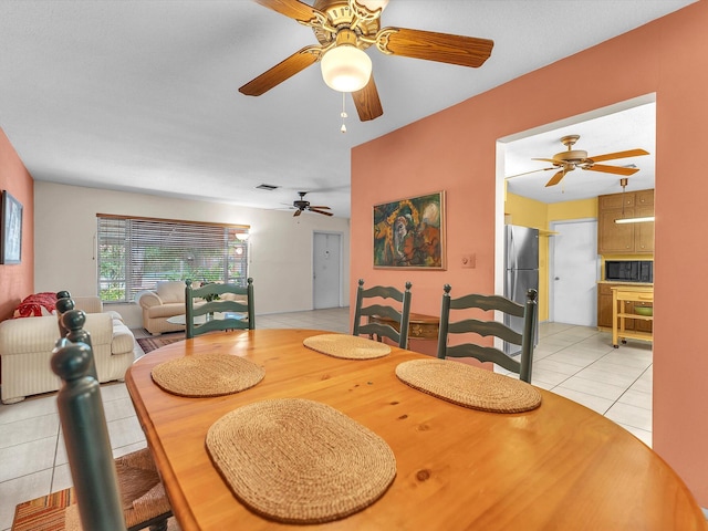 tiled dining space featuring ceiling fan