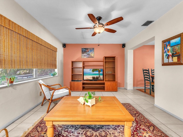 tiled living room with ceiling fan