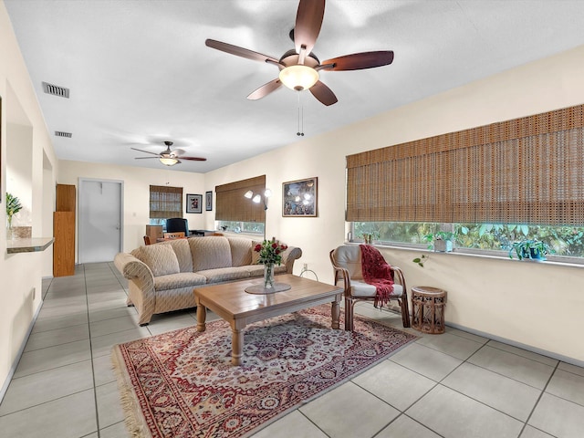 tiled living room featuring ceiling fan