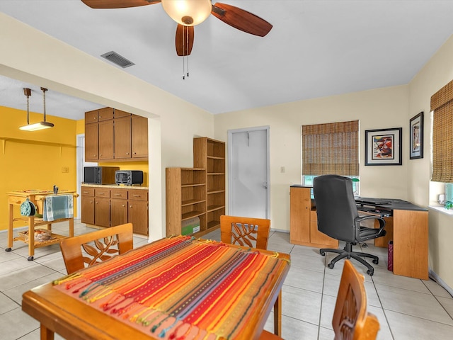 dining space featuring ceiling fan and light tile floors