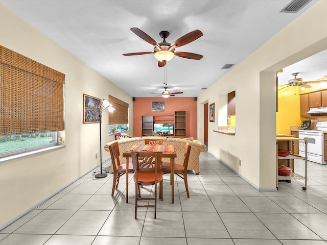 dining room featuring ceiling fan and light tile flooring