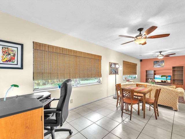 tiled home office featuring ceiling fan