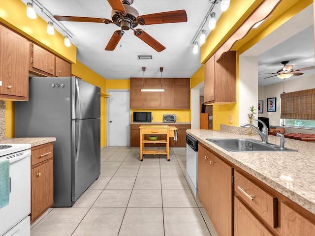 kitchen with sink, ceiling fan, light tile floors, and rail lighting