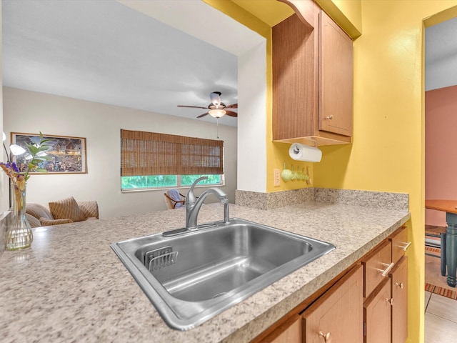 kitchen with ceiling fan, light tile flooring, and sink