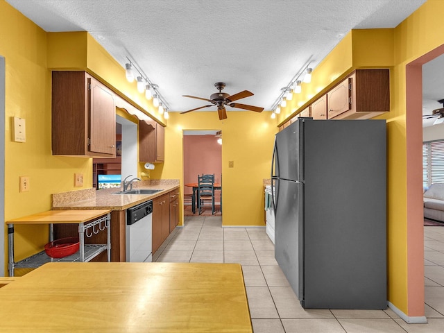 kitchen with black refrigerator, ceiling fan, and rail lighting