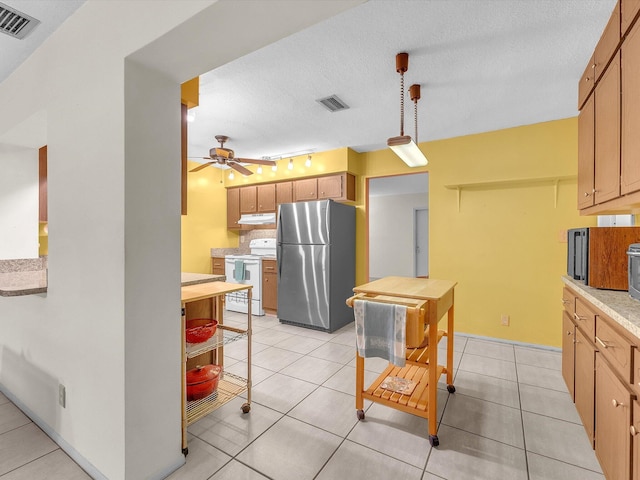 kitchen with ceiling fan, pendant lighting, white range with electric stovetop, light tile floors, and stainless steel refrigerator