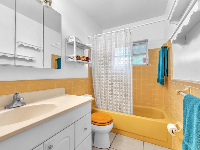 full bathroom with tile flooring, oversized vanity, tile walls, and toilet