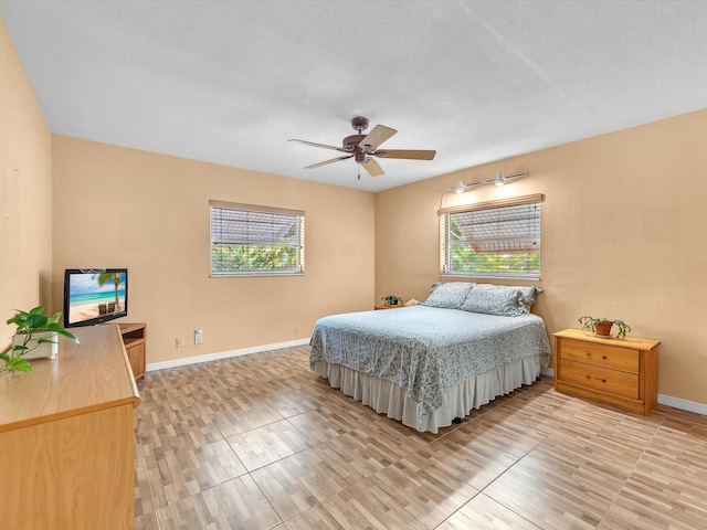 bedroom featuring ceiling fan and multiple windows