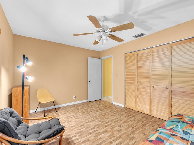 sitting room featuring tile flooring and ceiling fan