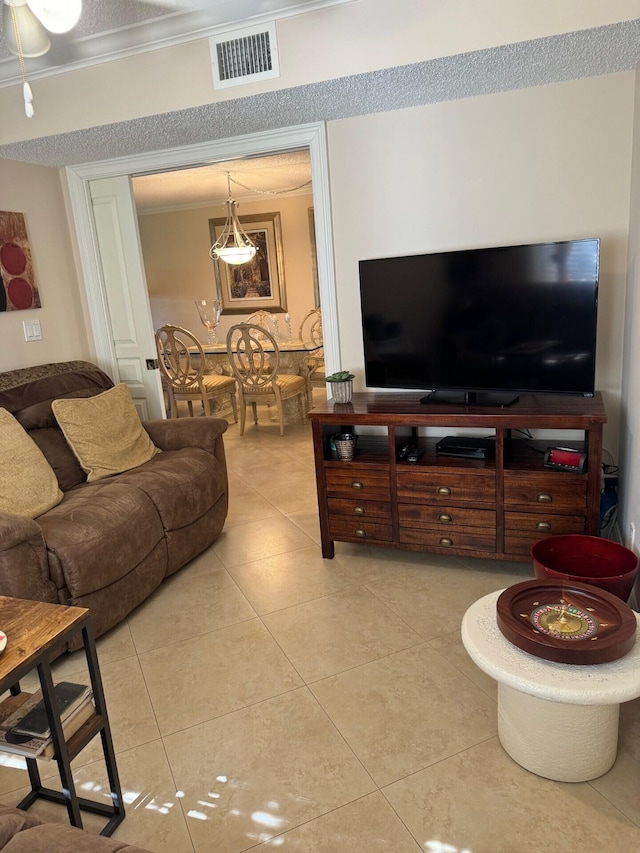 living room featuring ornamental molding and light tile patterned floors