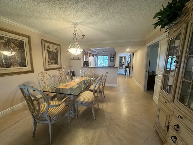 tiled dining area with crown molding and a textured ceiling