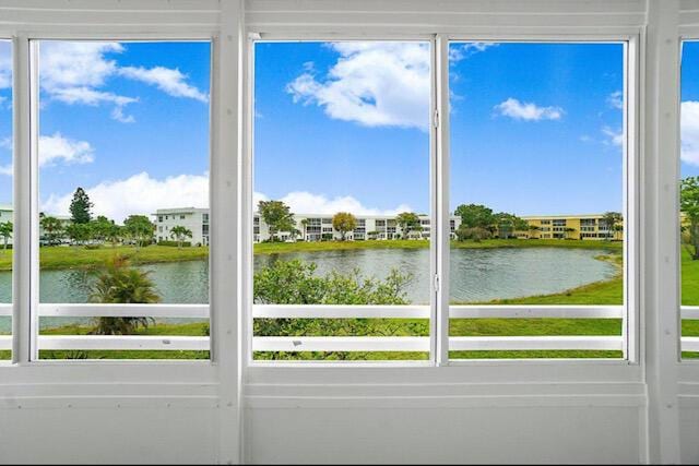 unfurnished sunroom featuring a water view