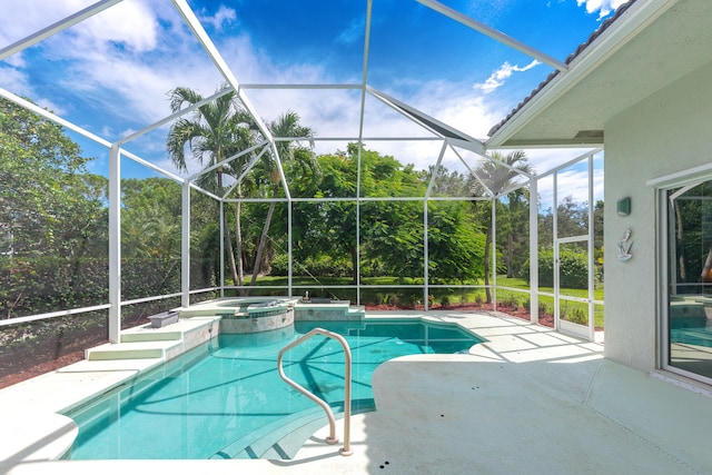 view of swimming pool featuring a patio area, a lanai, and an in ground hot tub