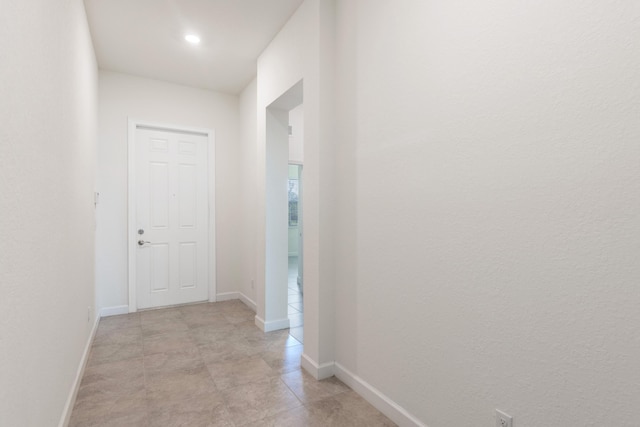 hallway with light tile patterned floors