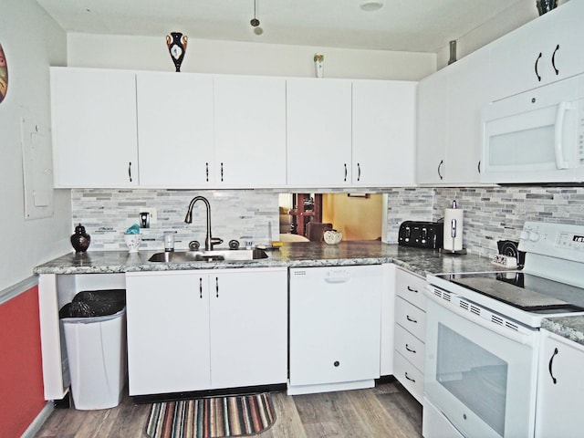 kitchen featuring sink, white cabinets, and white appliances