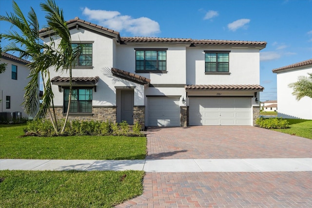 mediterranean / spanish-style house with central AC, a front lawn, and a garage